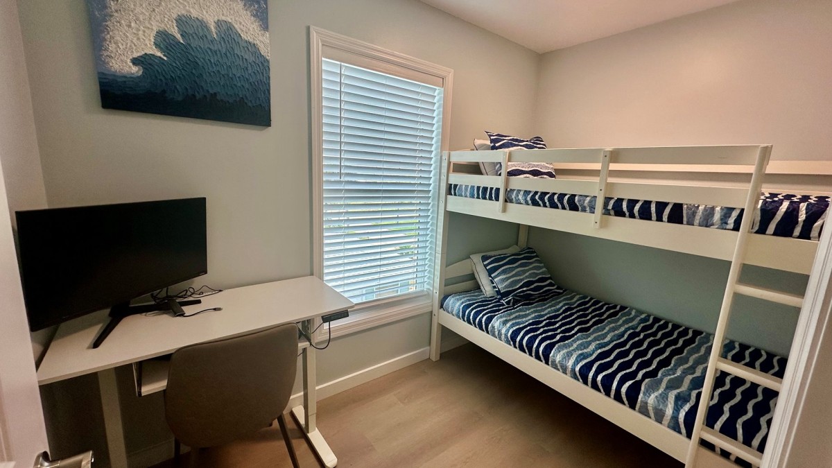 Bunk room with workspace and TV