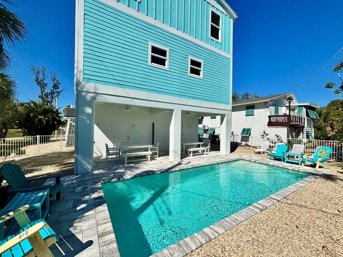 Pool beside the blue duplex